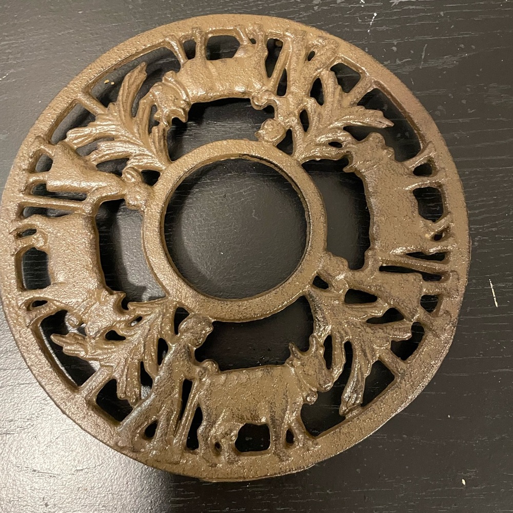 Vintage Cast Iron Trivet with boy and cow and girl with cow. EUC!